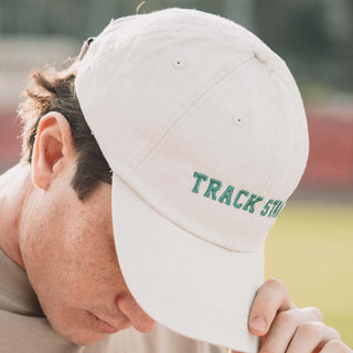 Man wearing Track Star hat looking down