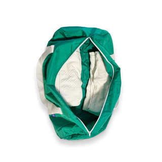 Green Track Star duffle bag laying open to show items inside 